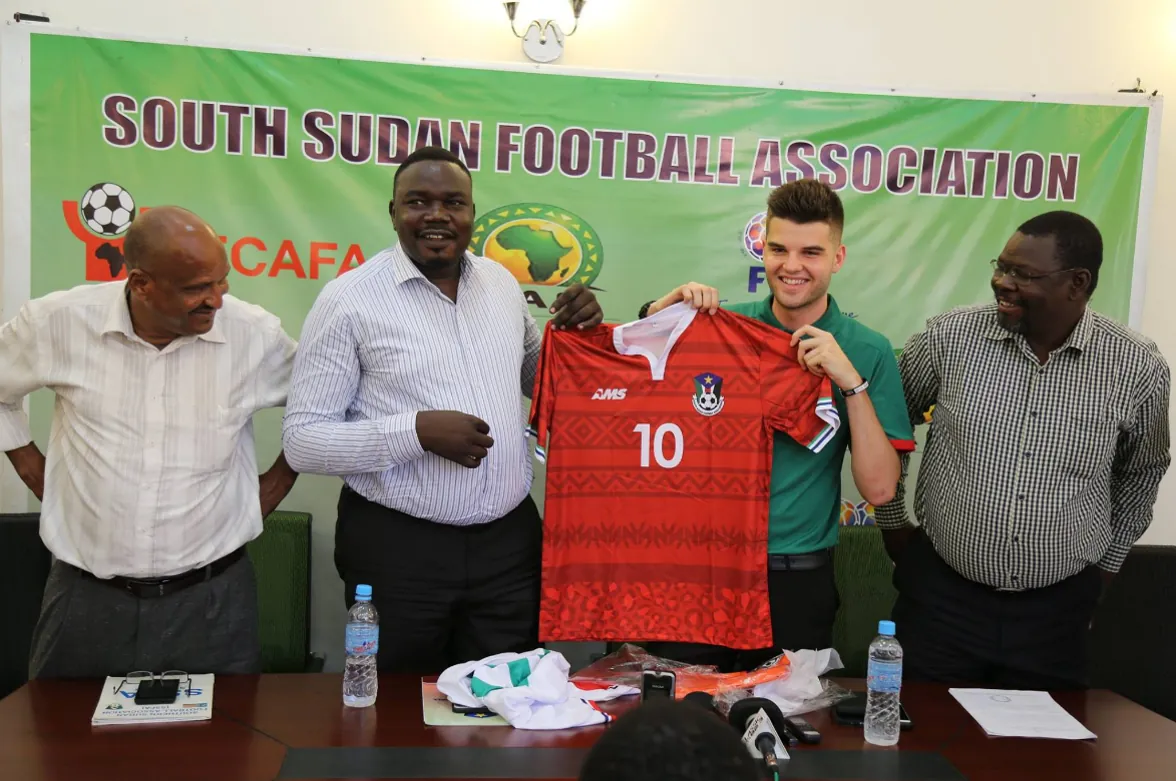 A new red South Sudan shirt is held up at a South Sudan Football Association press conference