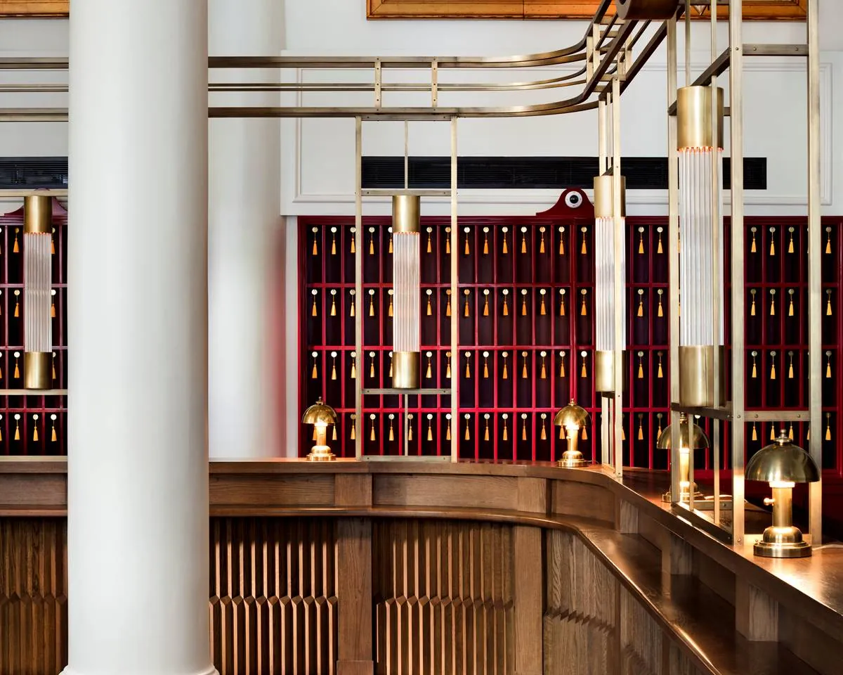 Rows of room keys with gold tassels behind the reception desk