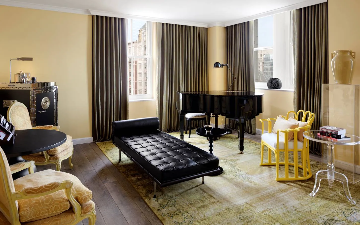 A suite with a grand piano, a leather daybed and a vintage safe